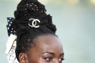 Lupita Nyong’o’s Bow-Adorned Updo Was Tailor-Made For A Chanel Show