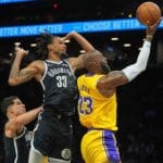 Doncic, James help Lakers rout Nets in Reaves’ return from injury