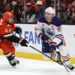 Jeffrey Viel lifts Connor McDavid off his skates in Game 3