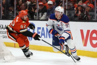 Jeffrey Viel lifts Connor McDavid off his skates in Game 3