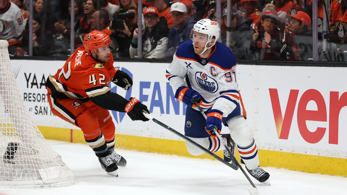 Jeffrey Viel lifts Connor McDavid off his skates in Game 3
